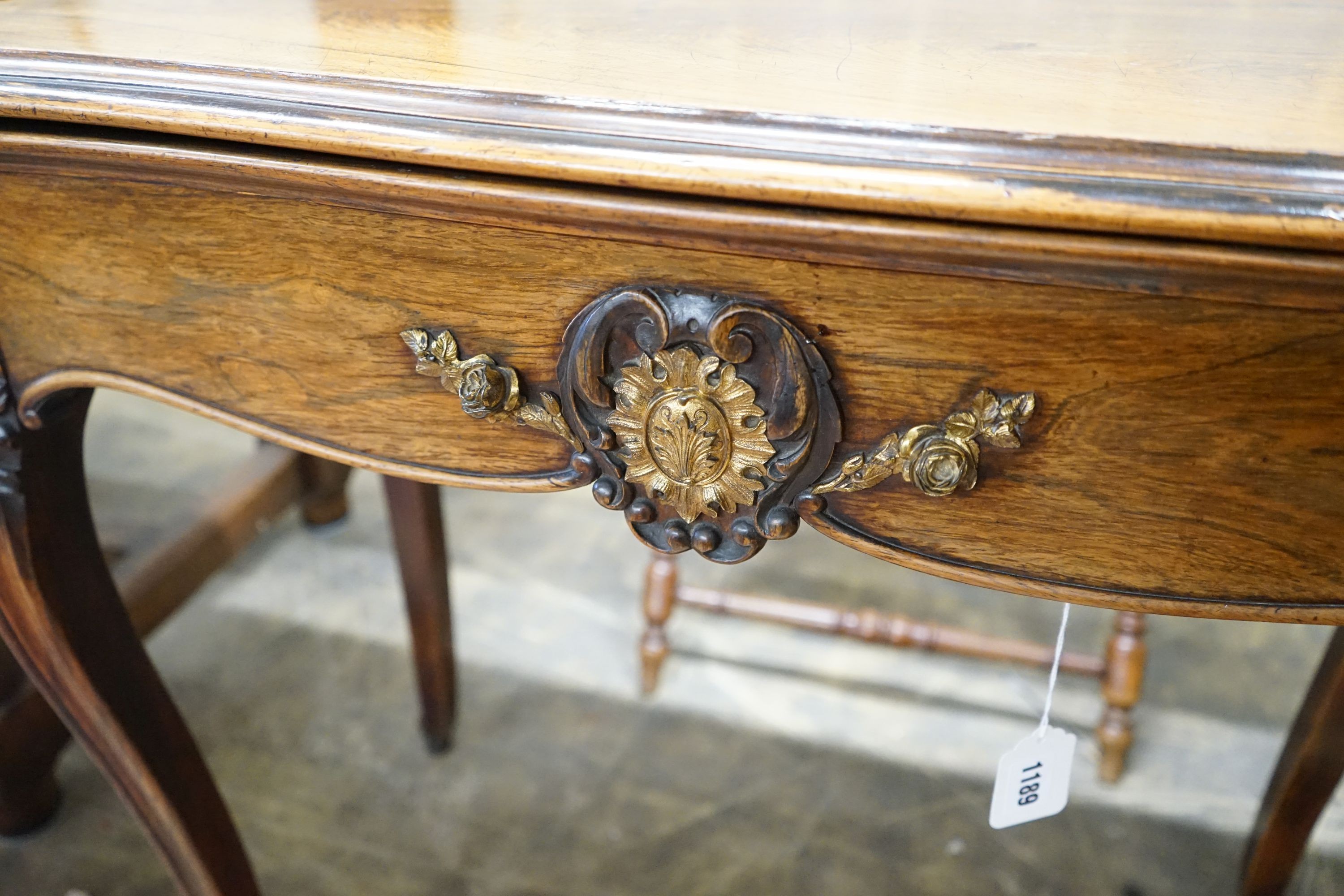 A 19th century French gilt metal mounted rosewood serpentine folding card table, width 82cm, depth 41cm, height 76cm